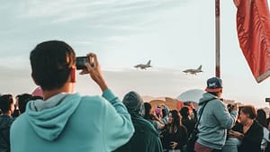 airplane flying with people as audience